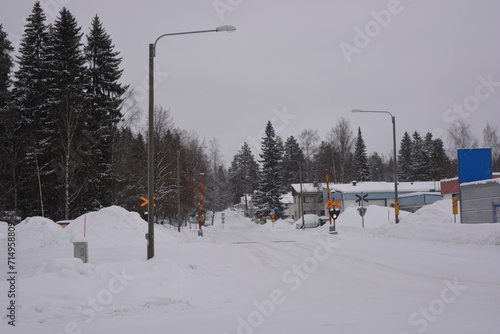 A small, cute winter town is Varkaus located in the province of North Savonia, Finland. Houses, roads, buildings, structures, trees, forests, fir trees, spruces covered with snow. photo