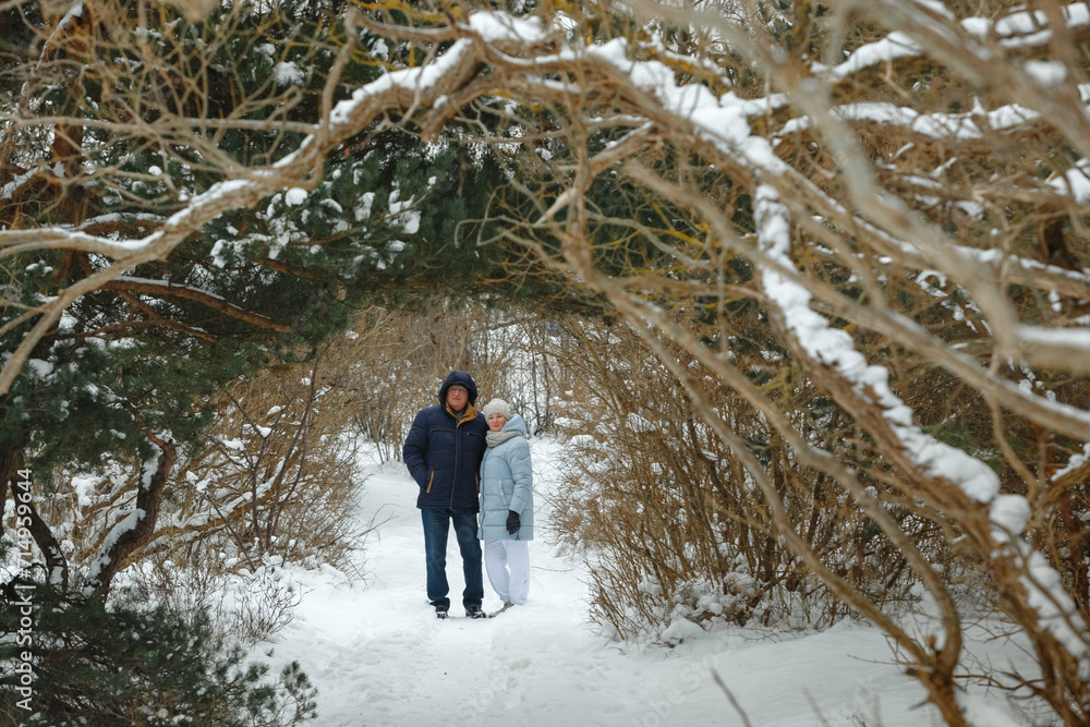 Portrait of an elderly couple outdoors in a winter forest
