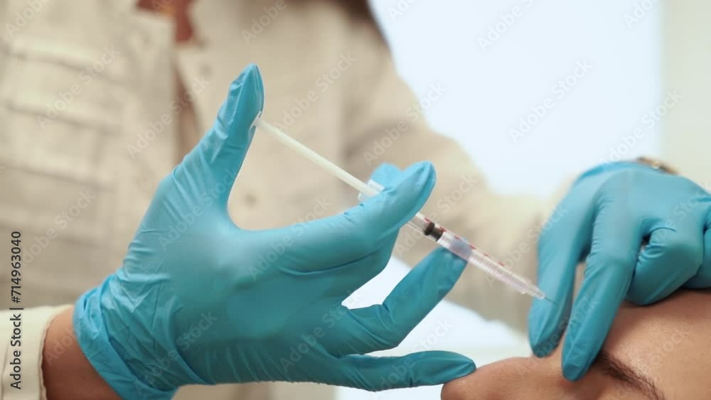 a doctor in a medical hospital is preparing to give an injection with a vaccine to a patient against a virus, close-up, vaccination a doctor in a medical hospital is preparing to give an injection with a vaccine to a patient against a virus, close-up, vaccination
