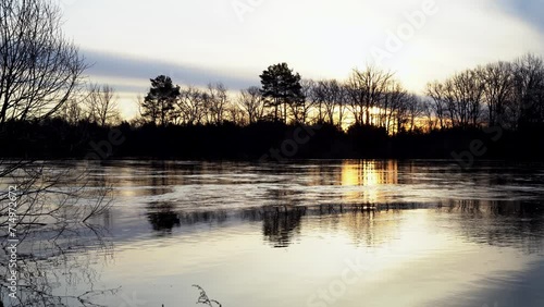 the flood of a wide river in high water at sunset, the concept of a screensaver and video wallpaper photo