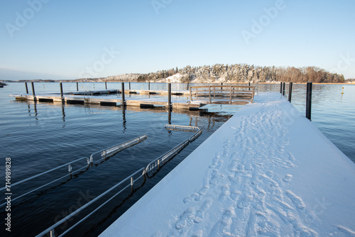 Swedish harsh beautiful winter concept: sunny view after snowfall on outdoor swimming area sometimes used by winter swimmers © Andrii