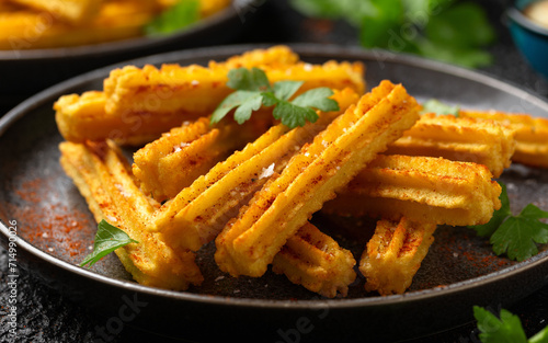 Crisp and golden Potato churros served with paprika and fresh parsley