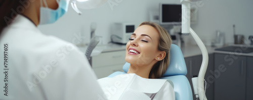 Beautiful woman sitting in dental chair while professional doctor fixing her teeth. Dental care concept