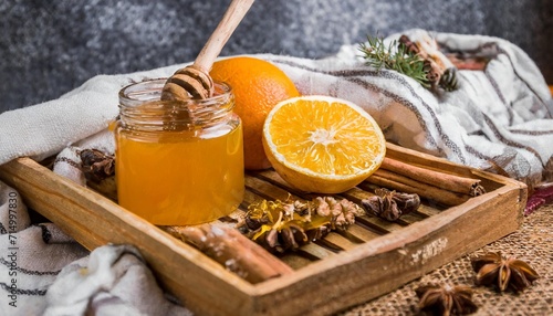 orange honey and spices on the wooden tray with plaid vertical