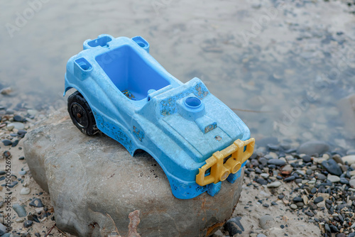 A children's plastic toy car, abandoned and forgotten on the seashore in Russia. © Irina Lu
