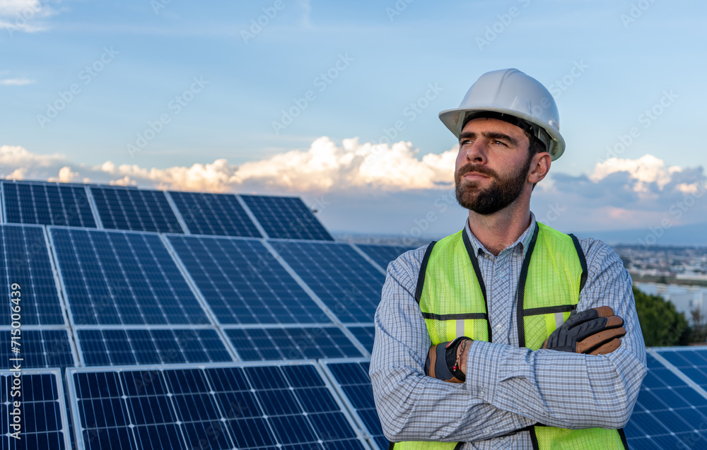 portrait of a professional engineer smiling, looking at horizon, concept of hope and future using renewable energy, solar panel power station and blue sky at the background portrait of a professional engineer smiling, looking at horizon, concept of hope and future using renewable energy, solar panel power station and blue sky at the background