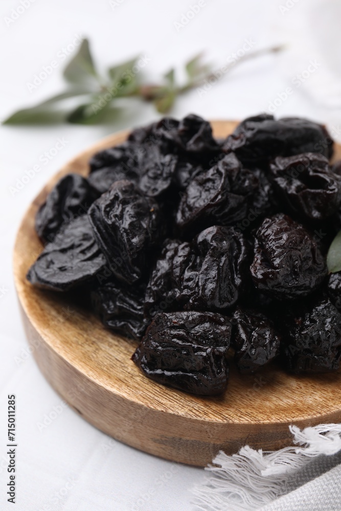 Sweet dried prunes on white table, closeup Sweet dried prunes on white table, closeup