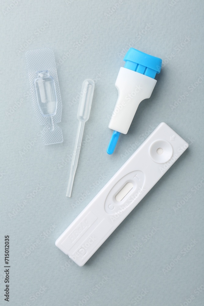 Disposable express test kit on light blue background, flat lay Disposable express test kit on light blue background, flat lay