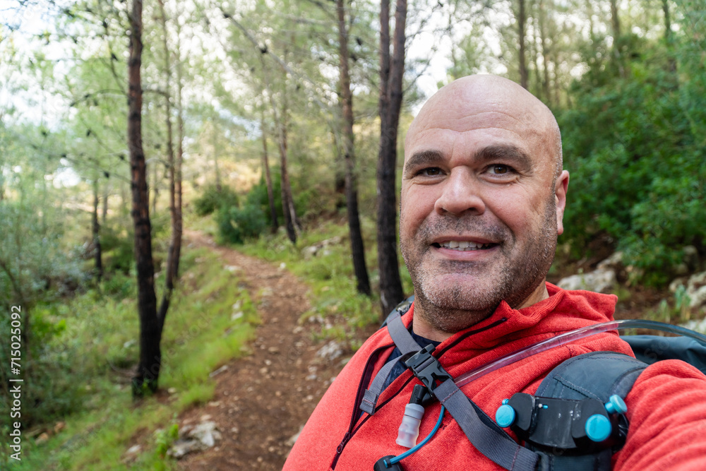  Hiker man takes a photo selfie outdors