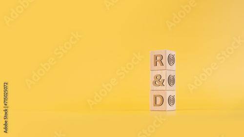 Photos R and D - research and development symbol, Wooden blocks with text, Business and R and D concept, Copy space, Yellow background
