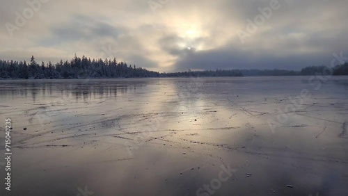 Ice skating on a frozen mountain lake in the Alps.