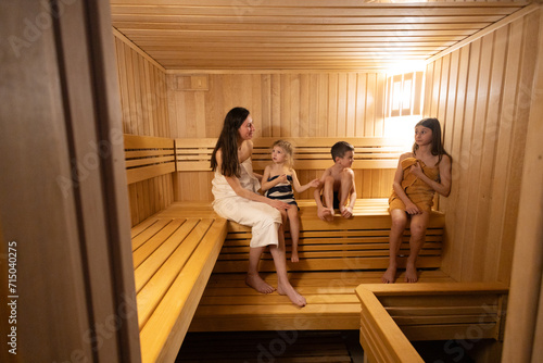  Family resting in sauna. Family vacation in spa