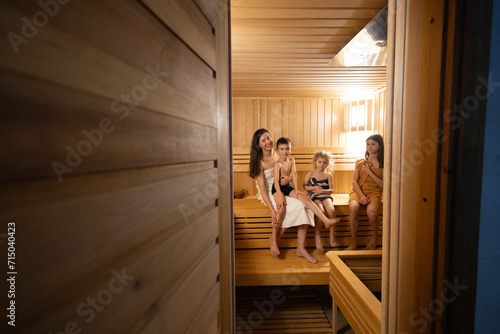 Family resting in sauna. Family vacation in spa
