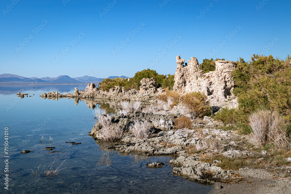 Shoreline of a calm Mono Lake desert landscape and clear blue sky in California