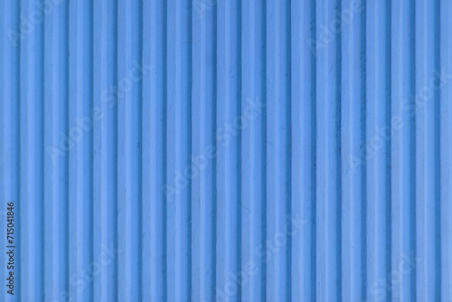 Old blue concrete background wall with vertical line ribbed. Stripes as a texture.