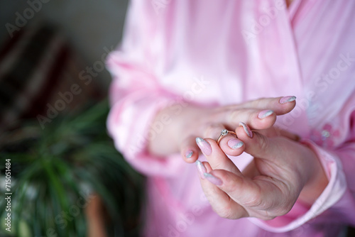 The girl tries on a wedding ring on her finger. Preparation for the wedding ceremony.
