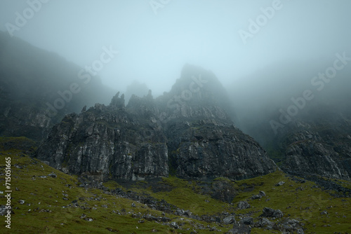 Atmospheric view of high sharp cliffs covered in fog. The Old Man of Storr covered in fog. The Isle of Skye, Scotland, UK © George