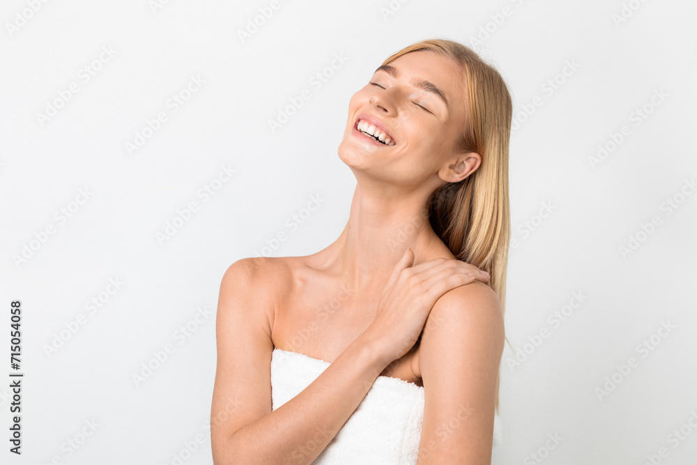 woman with eyes closed touching smooth skin on shoulder, studio woman with eyes closed touching smooth skin on shoulder, studio