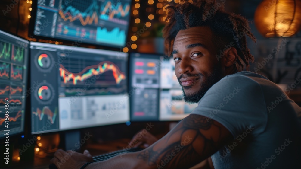 Smiling analyst with tattoos using multiple monitors for market trend analysis