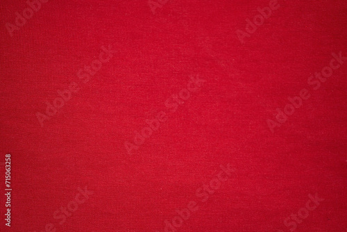 Knitted red background. Knitted knitted fabric is red. Red background photo