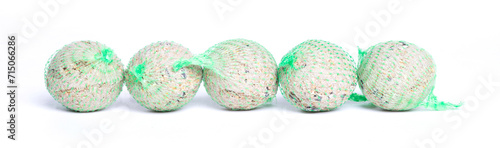 Foto Fat balls for feeding wild garden birds, suet, in nets, isolated on white backgr