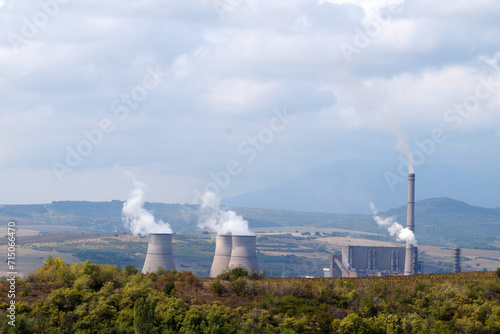 thermal power plant with smoking pipes against the backdrop of mountains