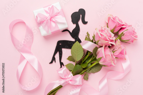 Composition with pink roses, gift box and eight made of ribbon on color background, top view. Women's day concept © Liami