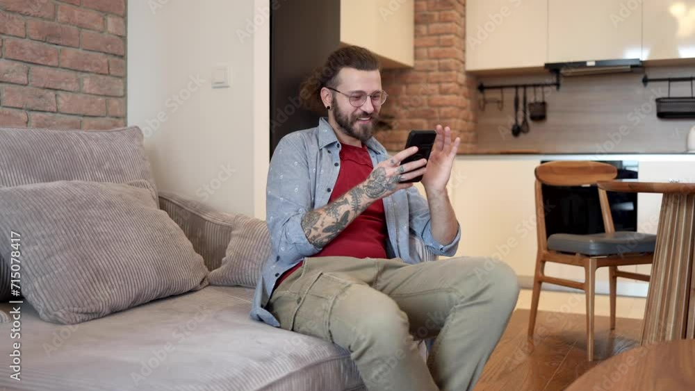 Man relaxing on the sofa and using smartphone Man relaxing on the sofa and using smartphone