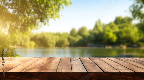 Wooden tabletop near river background and blurred green landscape for displaying or mounting your products