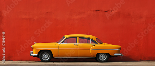 A yellow retro car on a red wall background in a minimal style