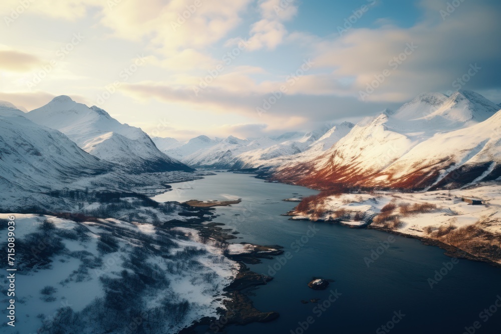 an aerial view of snow covered mountains and a body of water with a boat in the middle of the water.