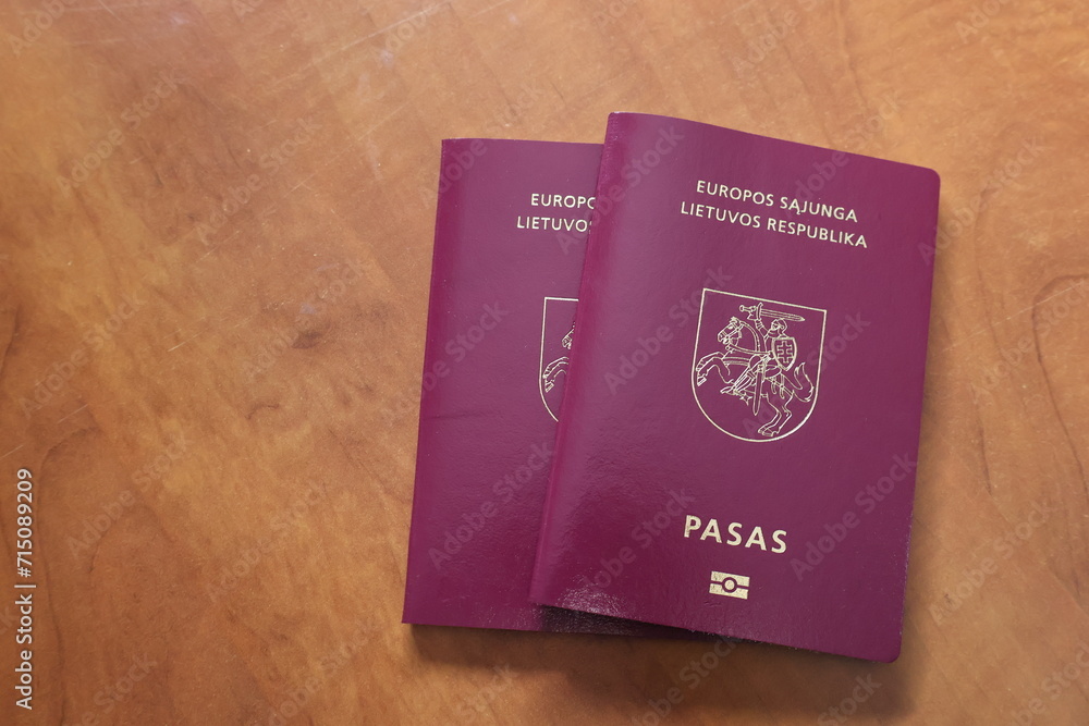 Two Lithuanian passports are placed on the table. Two Lithuanian passports are placed on the table.