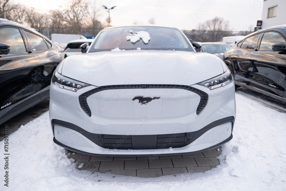 electric car Ford Mustang Mach-E in winter parking lot, EV Europe