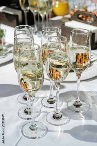 Champagne glasses on the table, beautiful lights. Luxury catering, set festive table.