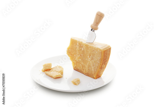 Aged parmesan cheese or parmigiano reggiano and a knife with a wooden handle for cheese on a white plate