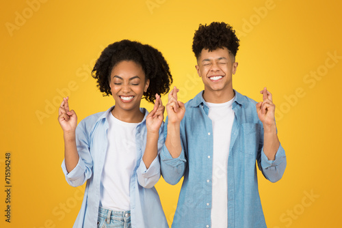 Fotografi A young woman and man with eyes closed and joyful smiles on their faces