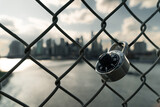 Lock in a fence with Manhattan skyline blurry in the background - New York