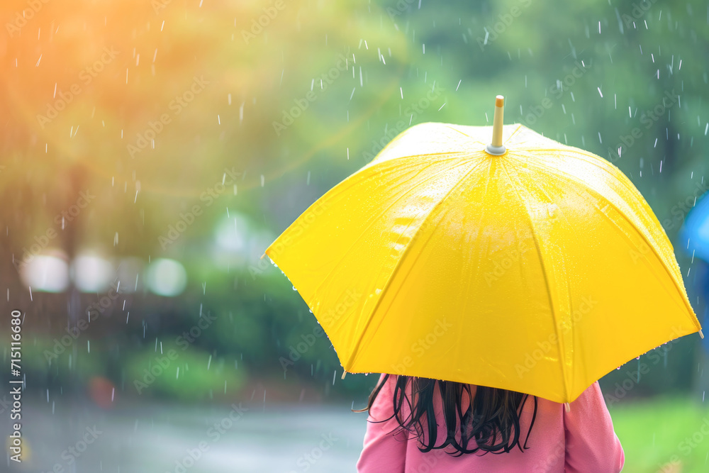 Girl with yellow umbrella in the rain on a rainy day. Close up