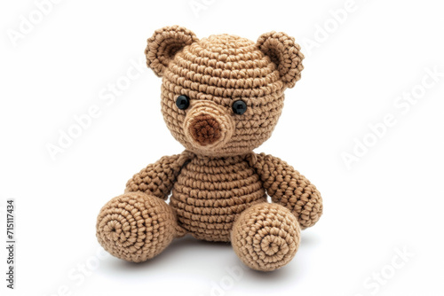 Amigurumi little teddy bear. Handicraft cute Crocheted doll. Isolated on white background.