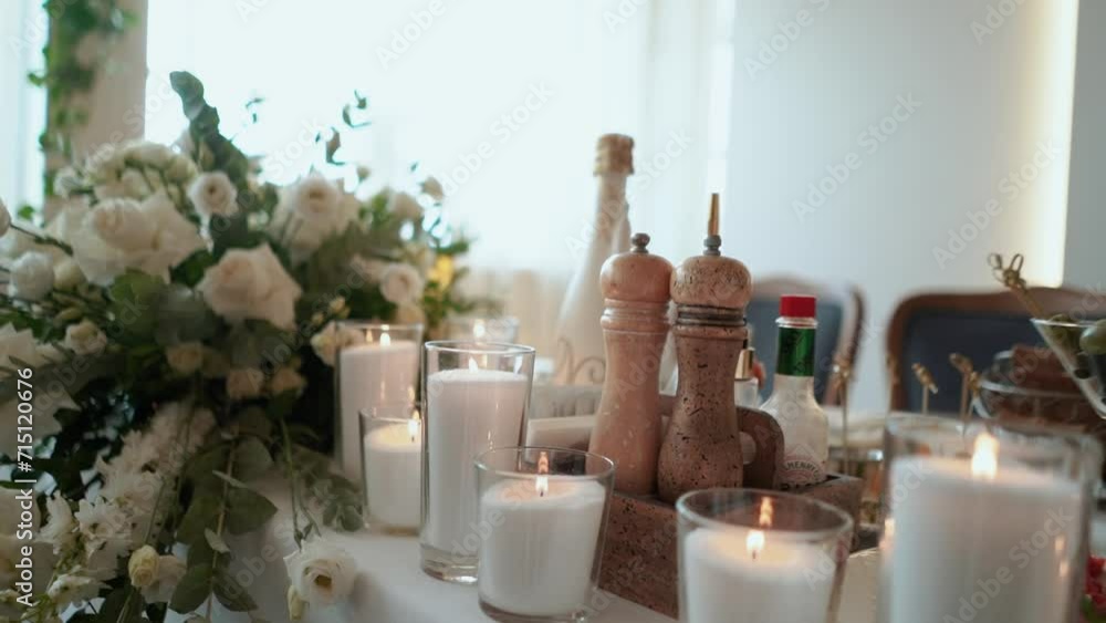 decoration of the wedding presidium for the banquet, table of the bride and groom, many roses and other flowers, delicious dishes on the festive table, close-up decoration of the wedding presidium for the banquet, table of the bride and groom, many roses and other flowers, delicious dishes on the festive table, close-up