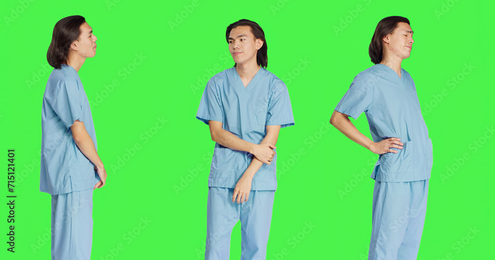 Asian person medical assistant in studio wearing hospital uniform clothing, posing with confidence and having professional healthcare expertise. Young guy with career in medicine. Asian person medical assistant in studio wearing hospital uniform clothing, posing with confidence and having professional healthcare expertise. Young guy with career in medicine.