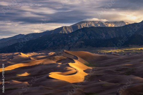 Sunrise in Great Sand Dunes National Park in Colorado with mountains in the background