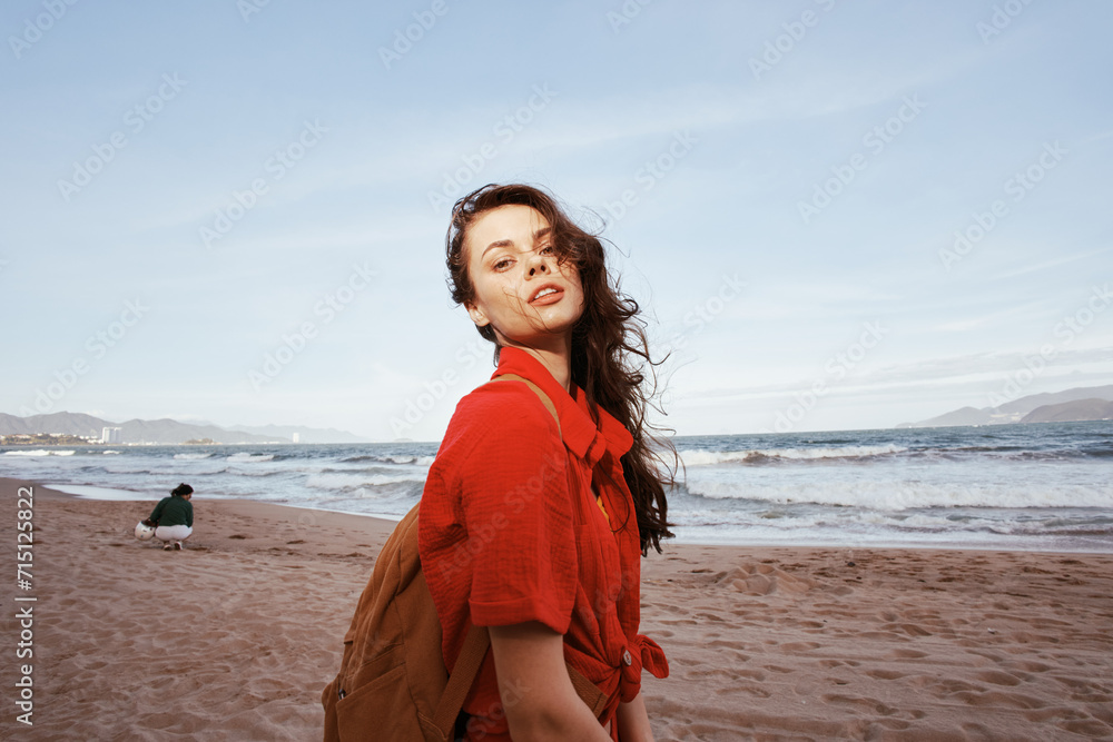 Smiling Woman Having Fun under the Sunny Blue Sky at the Beach with Red Clothes Smiling Woman Having Fun under the Sunny Blue Sky at the Beach with Red Clothes