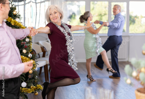 Photography Smiling adult lady in elegant clothes dancing in couple latin dance, energetic a