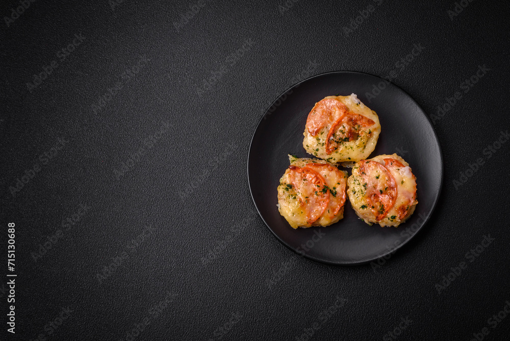 Delicious baked fish fillet with cheese, tomatoes, salt, spices and herbs Delicious baked fish fillet with cheese, tomatoes, salt, spices and herbs