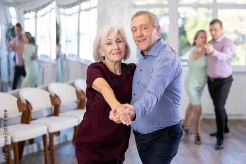 Elderly man and elderly woman dance couple tango dance in studio photo
