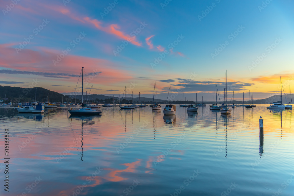 Fototapeta premium Sunrise, boats and reflections on the water