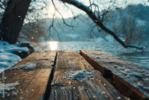 Wood board table with scenic lake background in winter.