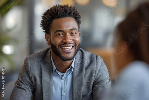 Smiling Manager Interviewing an Applicant In Office photo