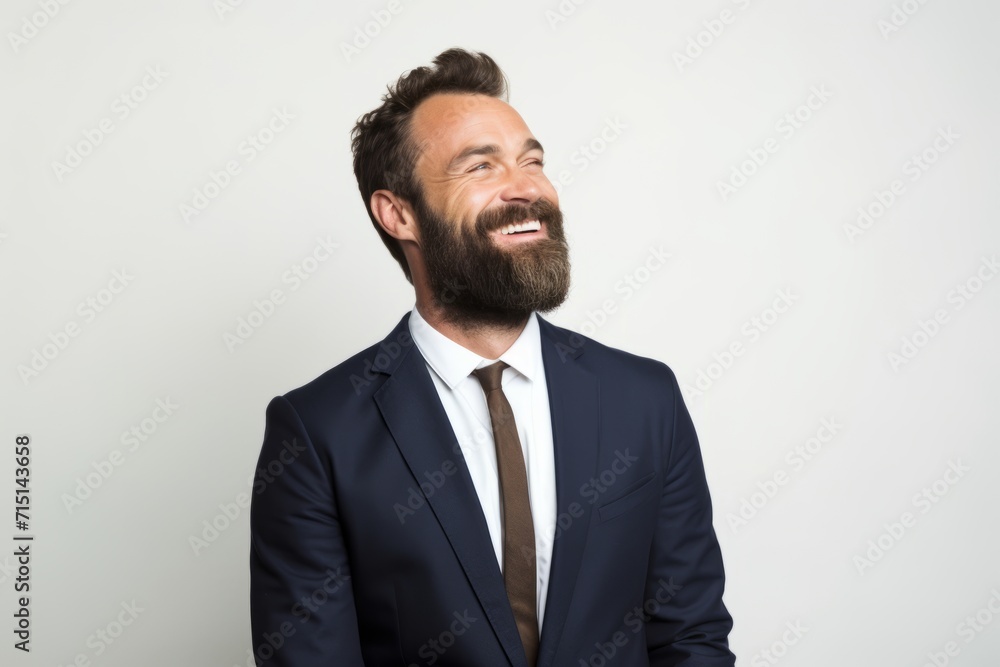 Handsome bearded man in suit looking at camera and smiling. Handsome bearded man in suit looking at camera and smiling.